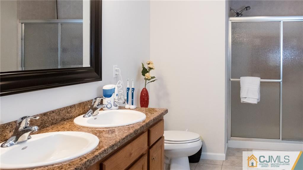 1746 Holly Road North Brunswick, NJ 08902 - Photo 14 of 17 a bathroom with a sink and a toilet