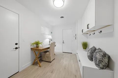 a view of a kitchen with white cabinets and white appliances