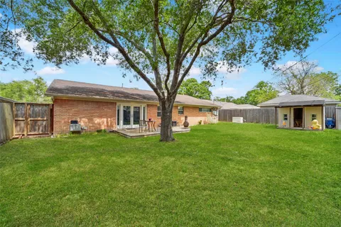 a view of a house with backyard and a sitting area