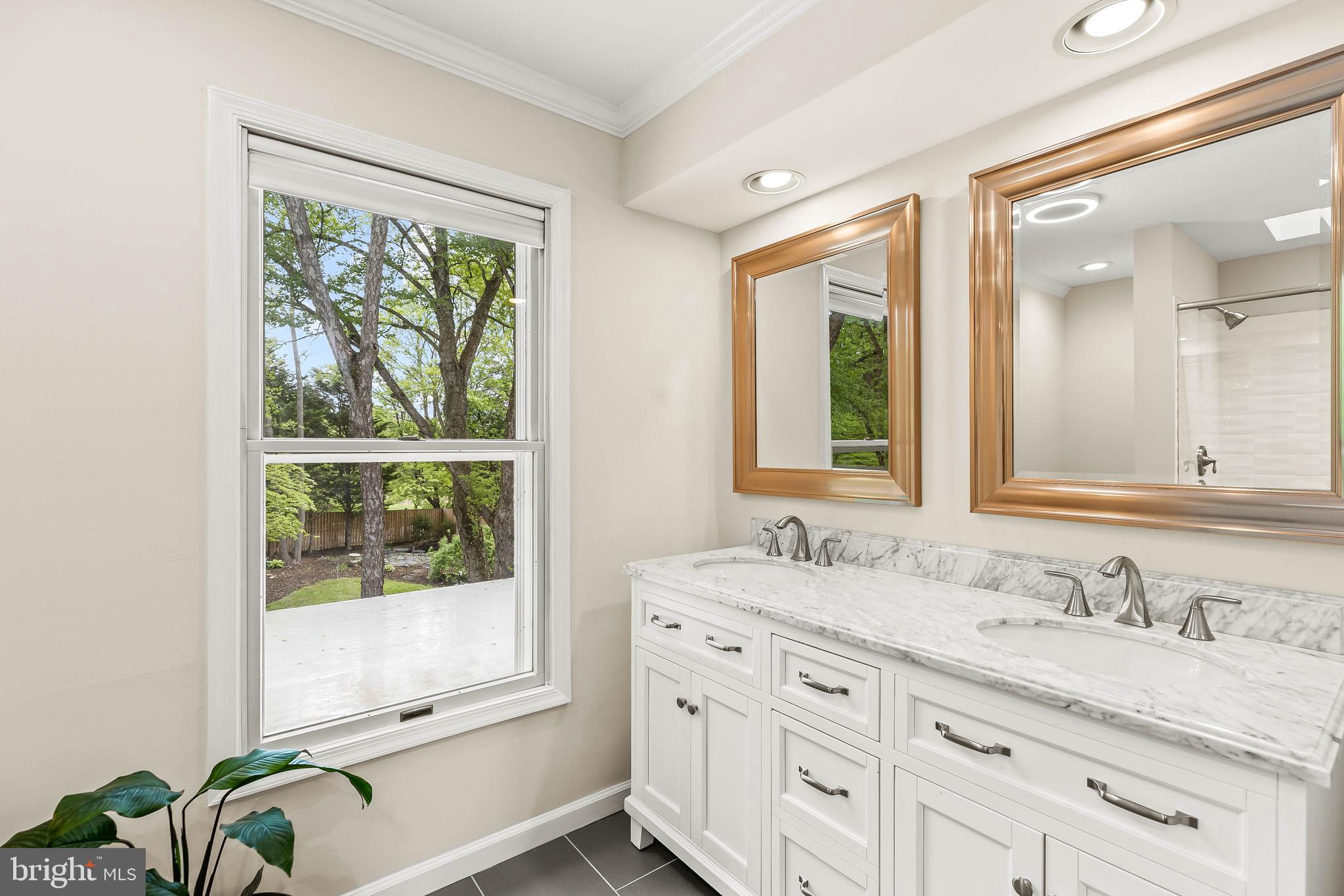 1868 Middlebridge Drive Silver Spring, MD 20906 - Photo 24 of 50 a bathroom with a granite countertop sink and a window