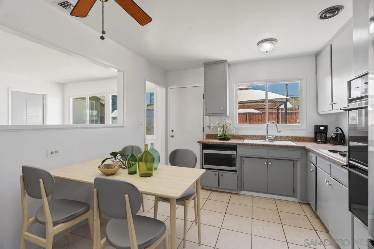 998 Joplin Drive El Cajon, CA 92021 - Photo 11 of 38 a kitchen with a table chairs and microwave