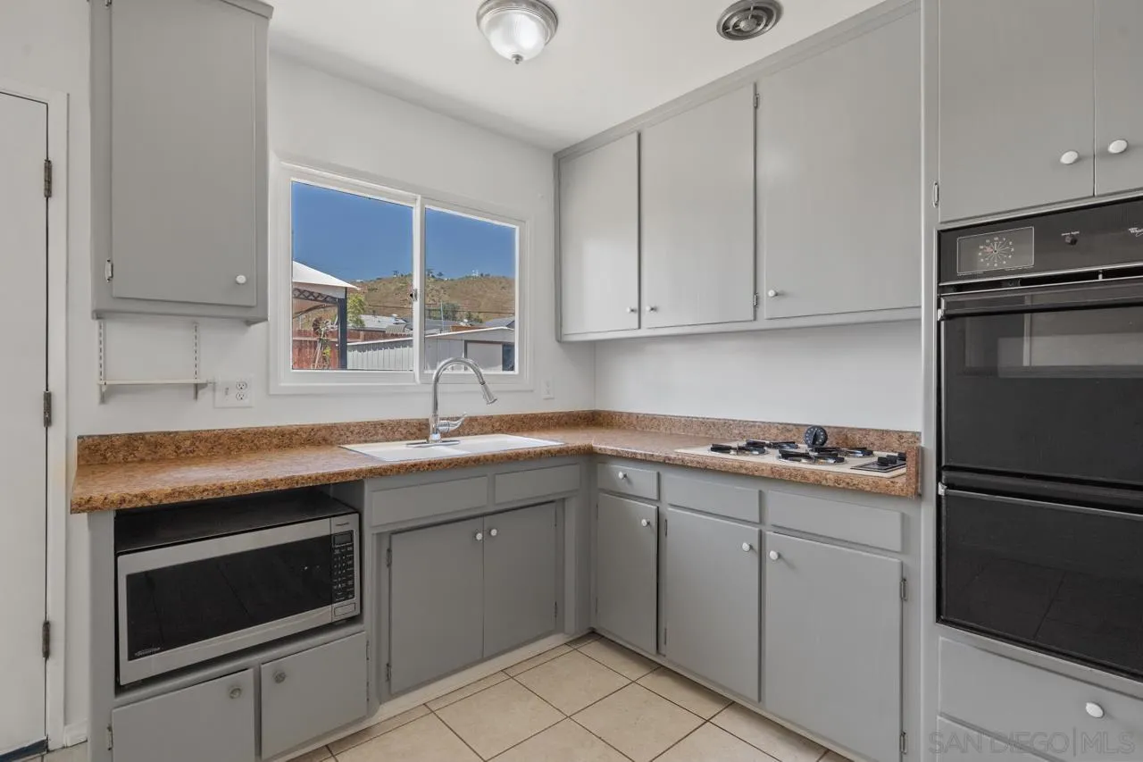 998 Joplin Drive El Cajon, CA 92021 - Photo 13 of 38 a kitchen with a sink stove and refrigerator