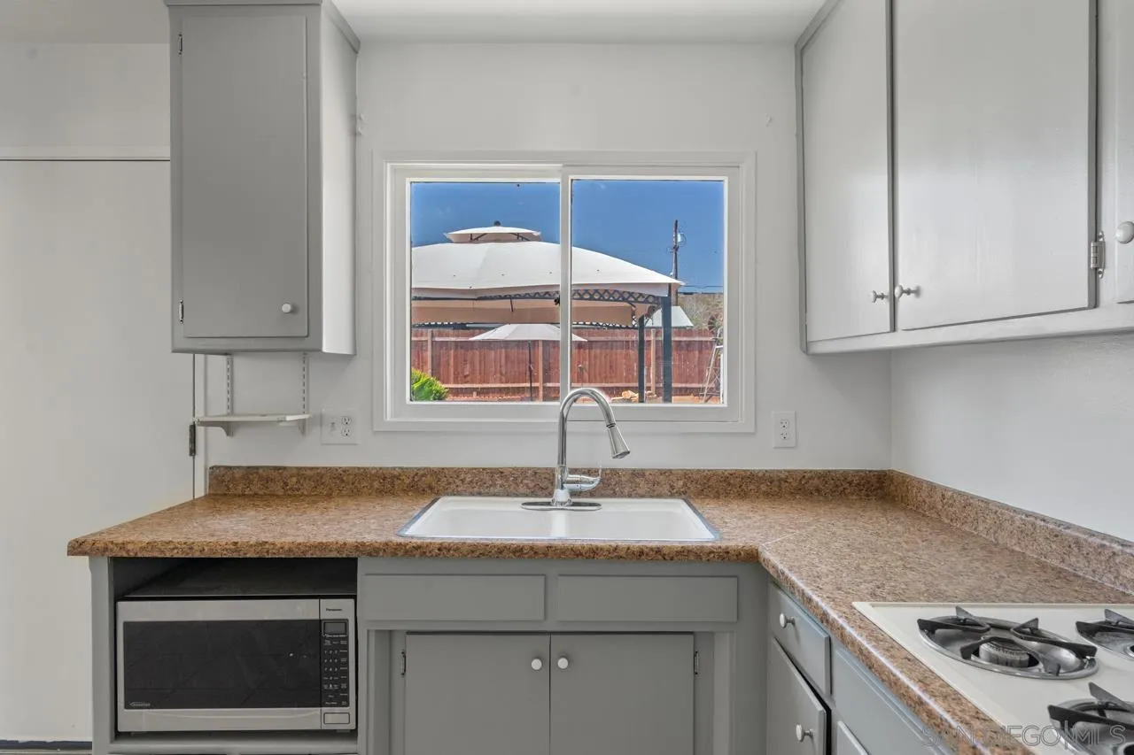 998 Joplin Drive El Cajon, CA 92021 - Photo 14 of 38 a kitchen with a sink stove and cabinets