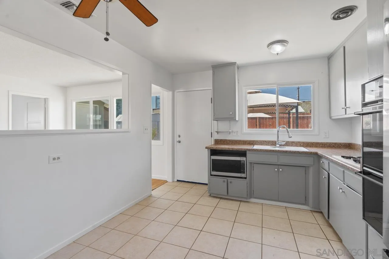 998 Joplin Drive El Cajon, CA 92021 - Photo 15 of 38 a kitchen with a sink and a stove top oven