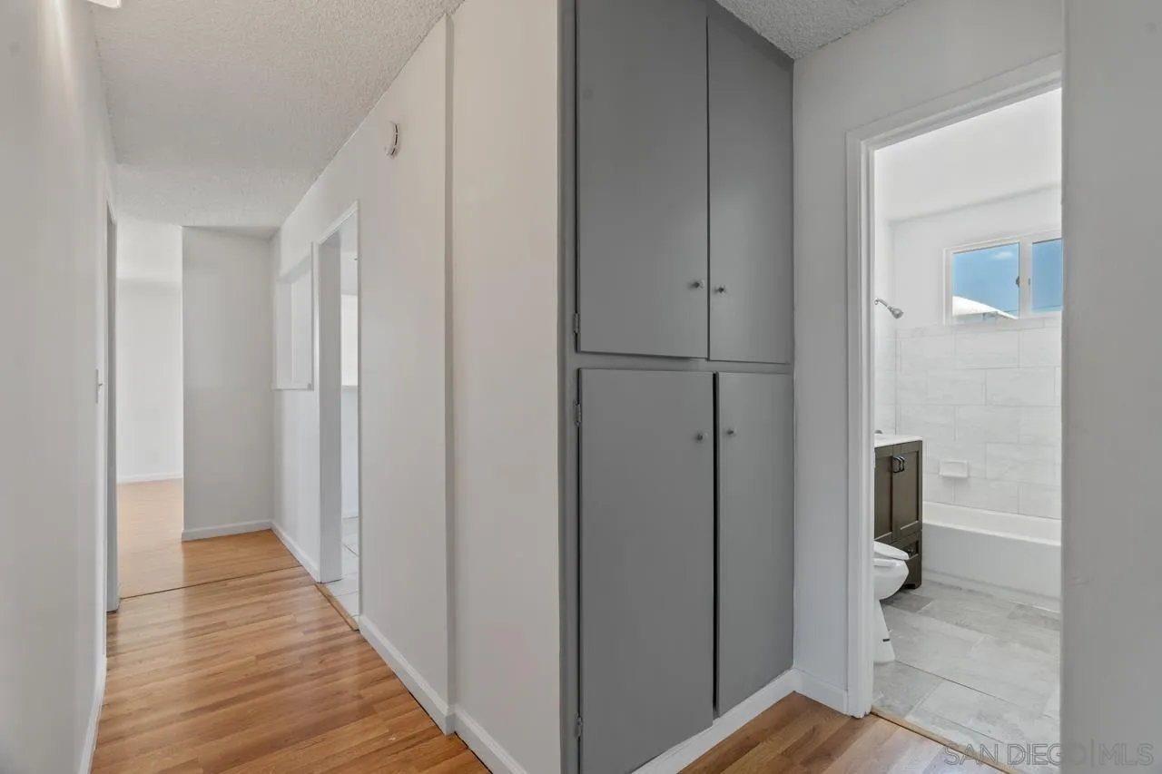 998 Joplin Drive El Cajon, CA 92021 - Photo 22 of 38 a view of a hallway with wooden floor and a bathroom