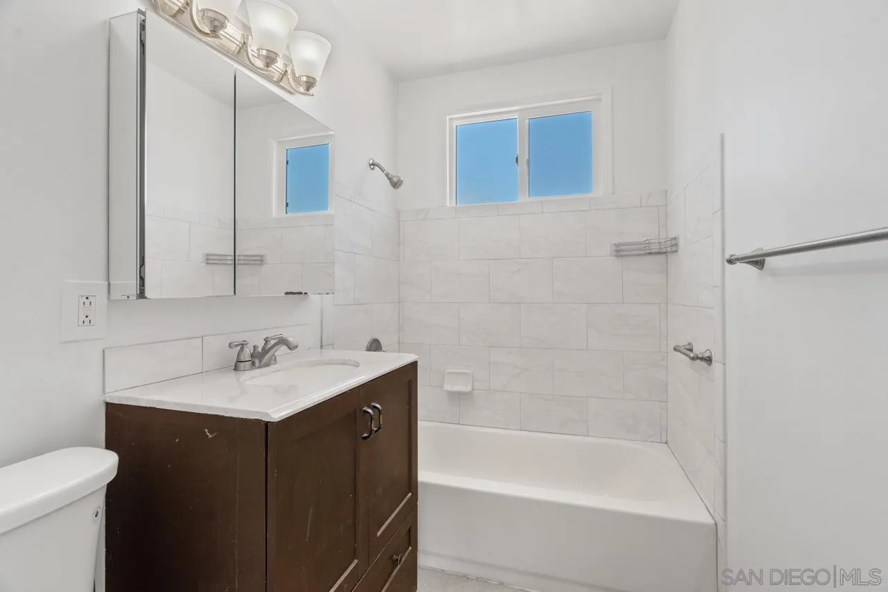 998 Joplin Drive El Cajon, CA 92021 - Photo 23 of 38 a bathroom with a sink mirror toilet and bathtub