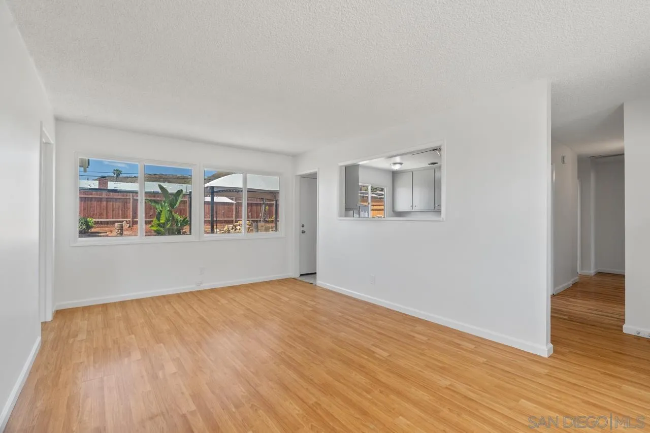 998 Joplin Drive El Cajon, CA 92021 - Photo 6 of 38 a view of an empty room with wooden floor and a window