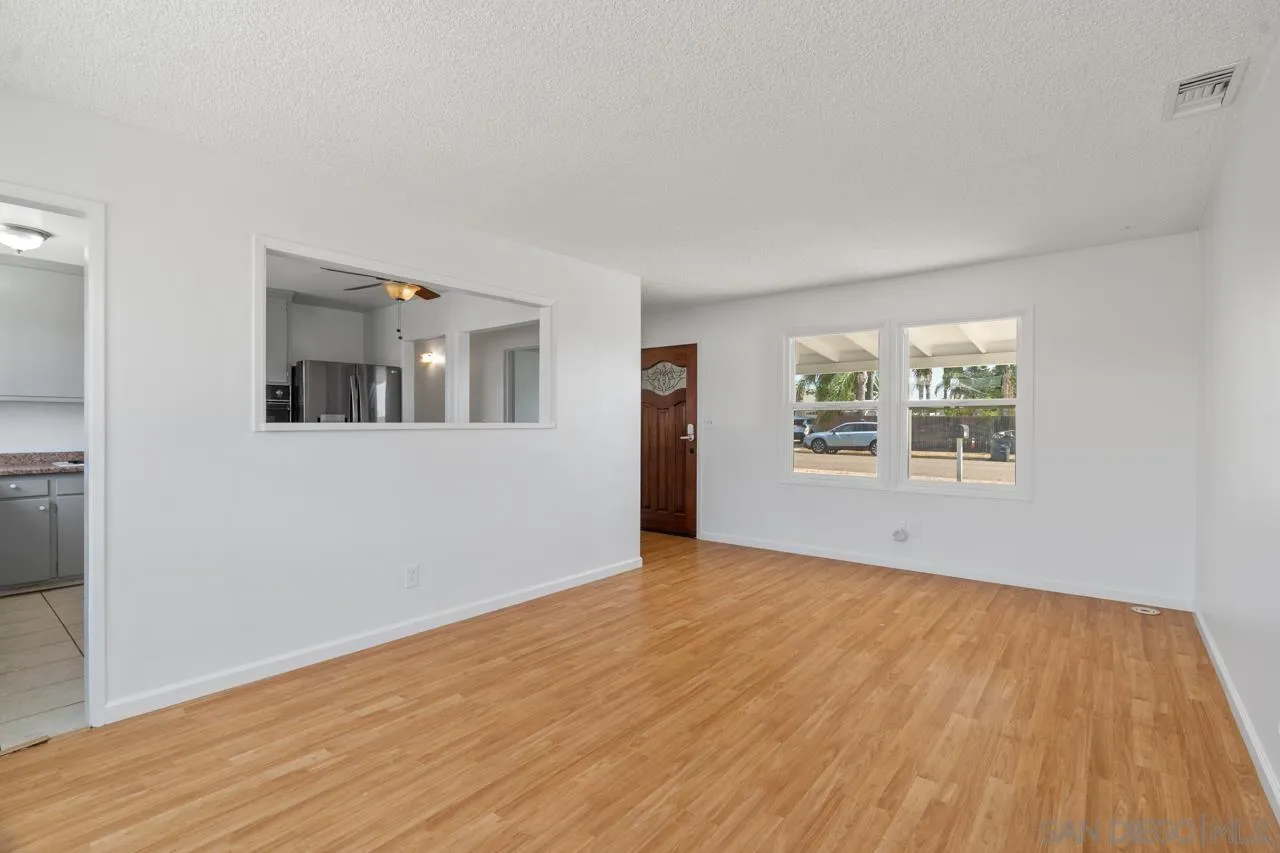 998 Joplin Drive El Cajon, CA 92021 - Photo 9 of 38 a view of an empty room with wooden floor and a window