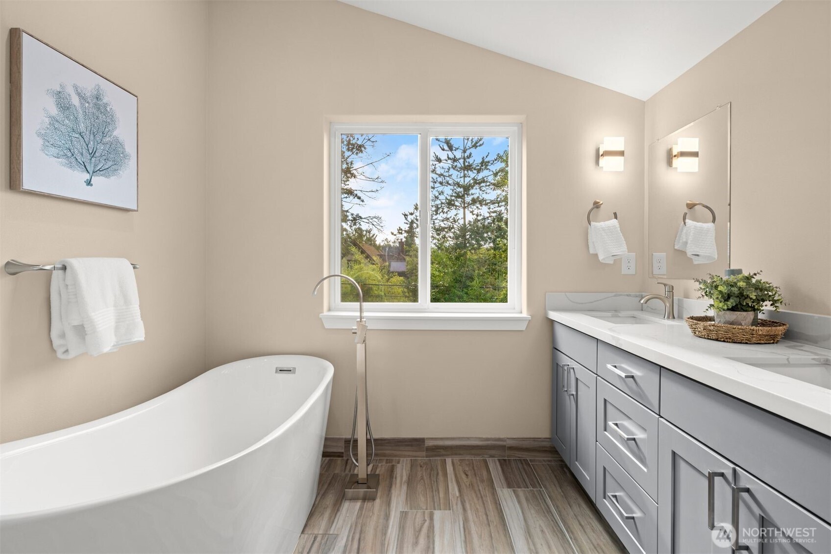 6419 Ellis Avenue South Seattle, WA 98108 - Photo 27 of 28 a bathroom with a granite countertop sink a large mirror a bathtub and next to a window