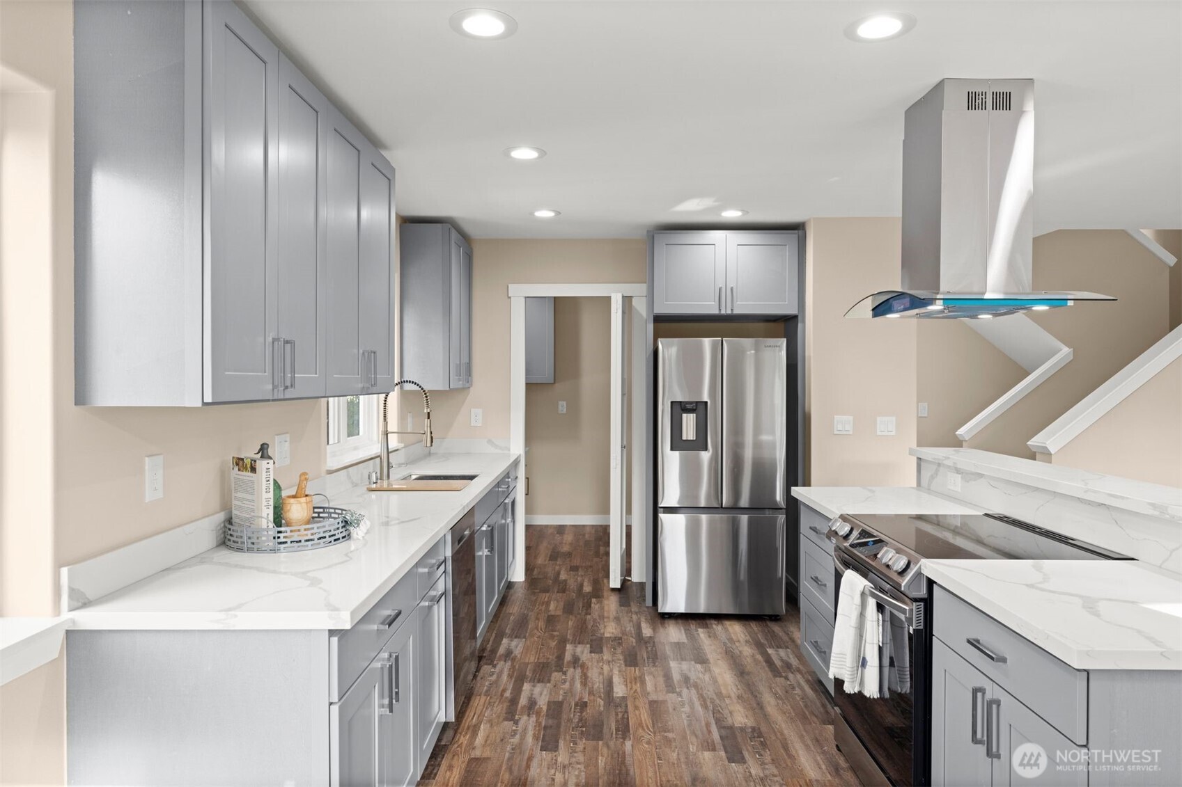 6419 Ellis Avenue South Seattle, WA 98108 - Photo 9 of 28 a kitchen with a sink stainless steel appliances and cabinets