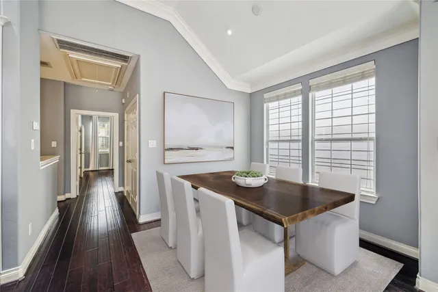 a living room with stainless steel appliances furniture and a kitchen view