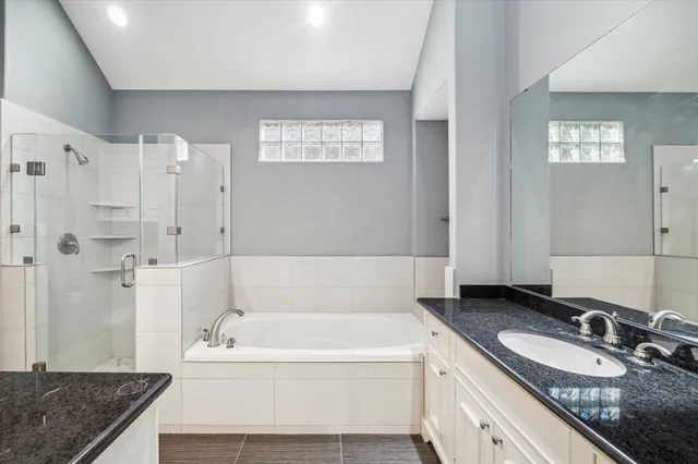 a bedroom with a large bed and a flat tv screen