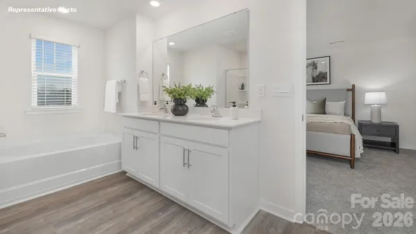 a bathroom with a double vanity sink and mirror