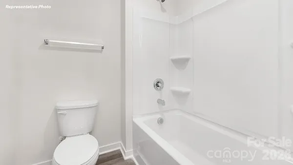 a bathroom with a toilet and bathtub