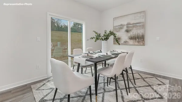 a view of a dining room with furniture and window