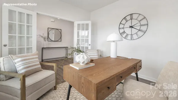 a living room with furniture a table and a mirror