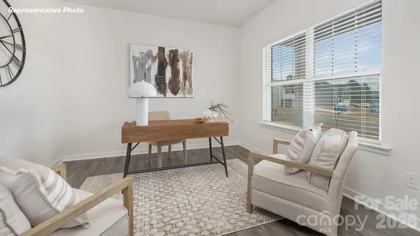 a living room with furniture a table and a window