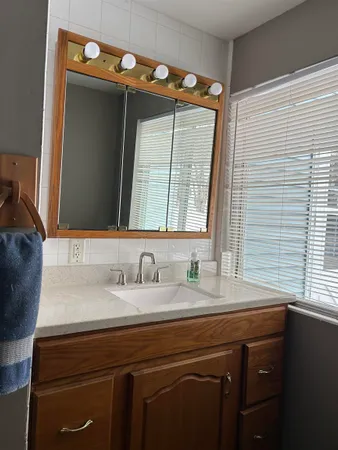 a bathroom with a sink vanity and a mirror