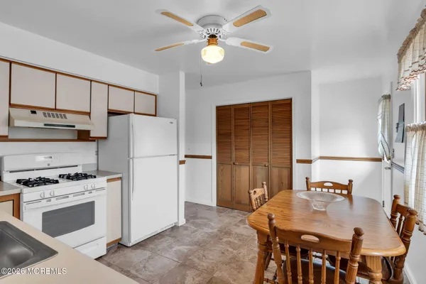 a kitchen with a stove a refrigerator and a sink