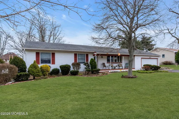 a front view of a house with garden and porch
