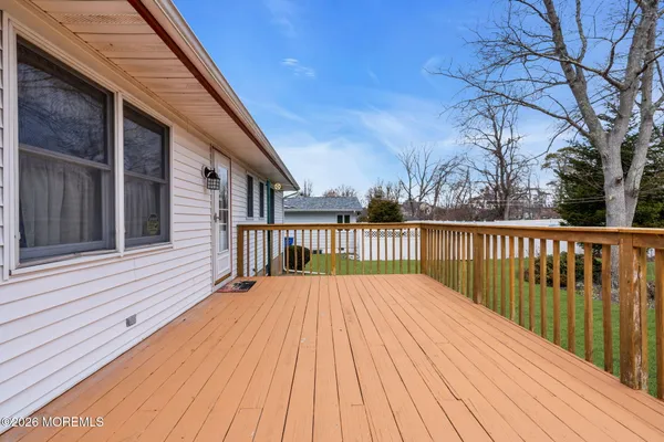 a balcony with wooden floor and fence