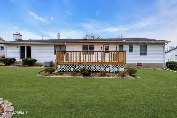 a front view of a house with a yard and outdoor seating