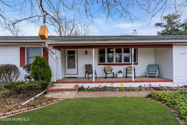 a front view of a house with a yard table and chairs