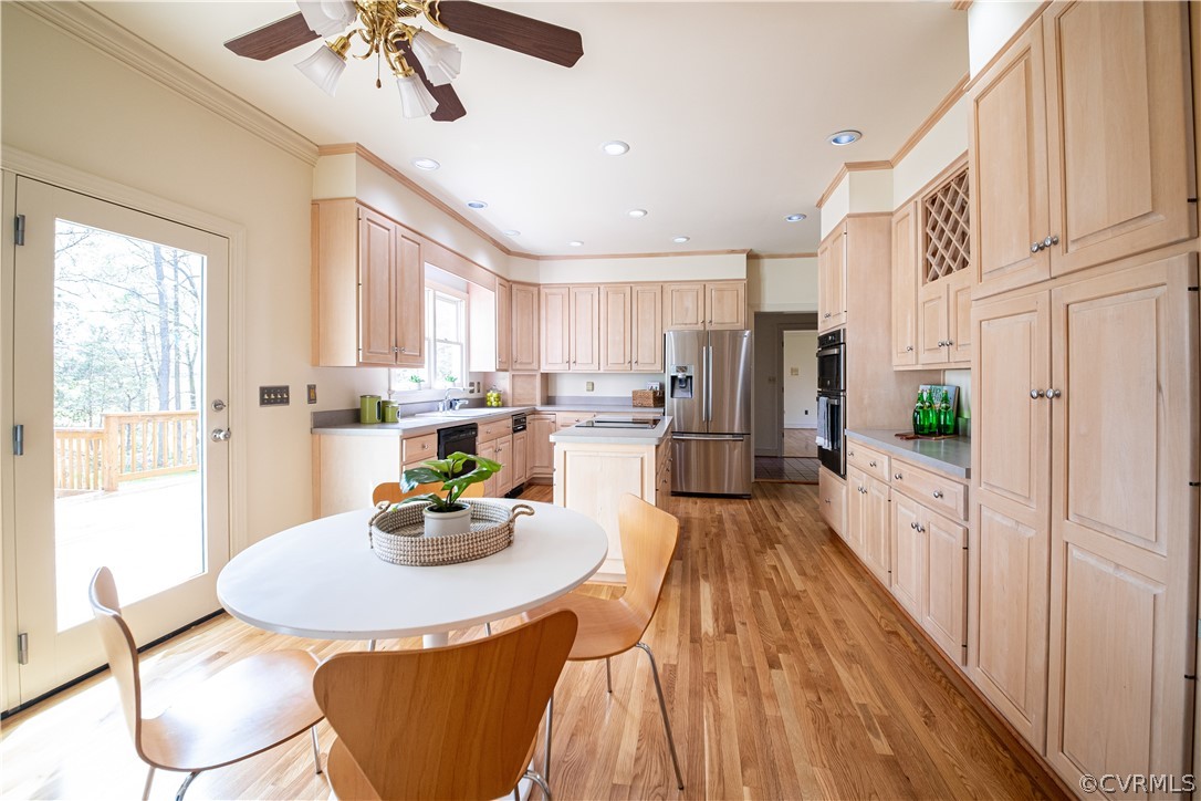 10497 Georgetown Road Mechanicsville, VA 23116 - Photo 16 of 50 a kitchen with stainless steel appliances kitchen island granite countertop a table chairs in it and wooden floors