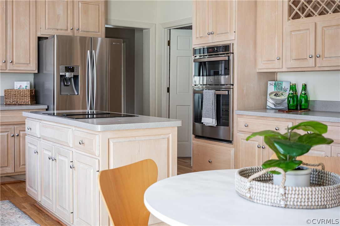 10497 Georgetown Road Mechanicsville, VA 23116 - Photo 23 of 50 a kitchen with stainless steel appliances kitchen island granite countertop a refrigerator a stove and white cabinets with wooden floor