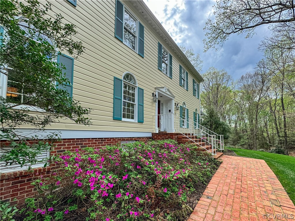 10497 Georgetown Road Mechanicsville, VA 23116 - Photo 3 of 50 a front view of a house with a yard and potted plants
