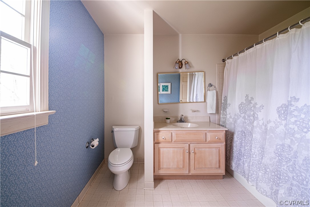 10497 Georgetown Road Mechanicsville, VA 23116 - Photo 34 of 50 a bathroom with a granite countertop toilet a sink a mirror and a shower