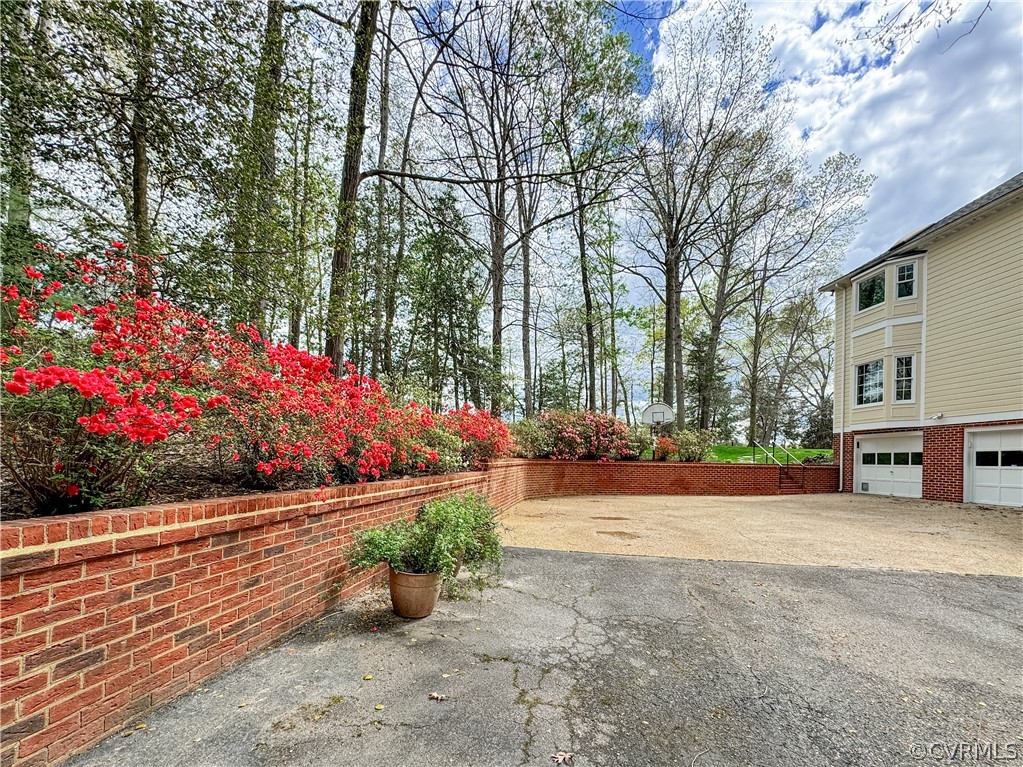 10497 Georgetown Road Mechanicsville, VA 23116 - Photo 45 of 50 a view of a garden with flowers and trees