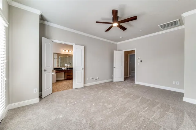 a view of a livingroom with a ceiling fan and kitchen view