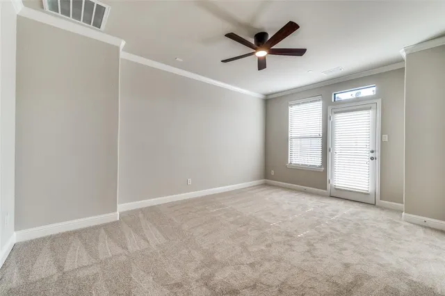 an empty room with closet and windows