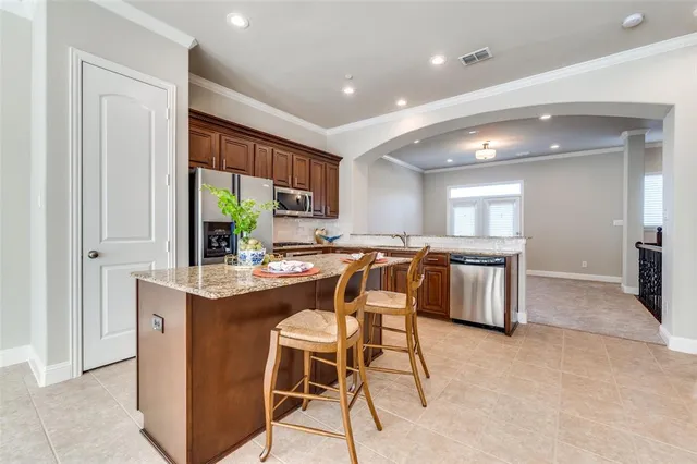 a kitchen with a table chairs sink and cabinets