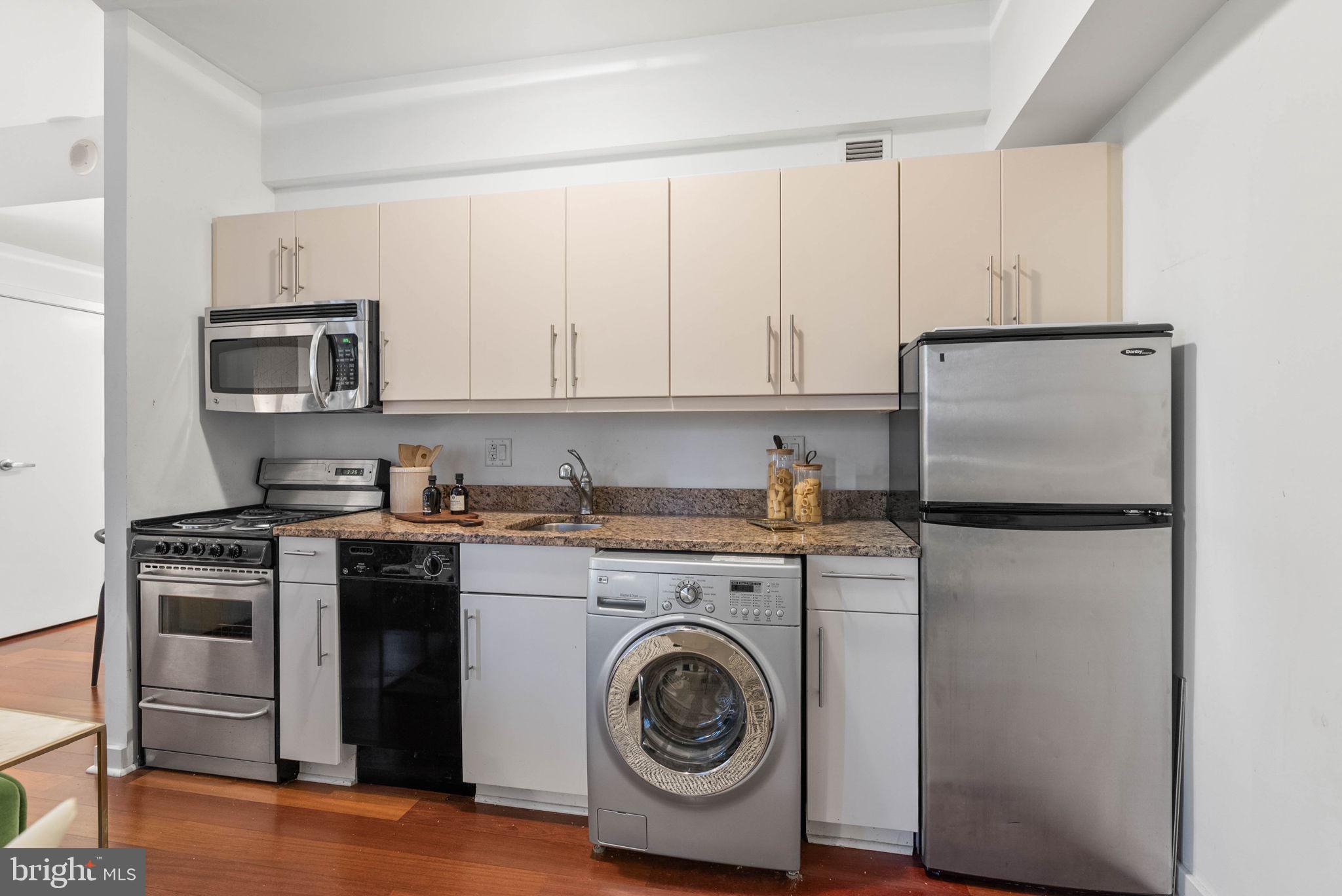 219 South 18th Street, Unit 404 Philadelphia, PA 19103 - Photo 12 of 24 a kitchen with a refrigerator sink and cabinets