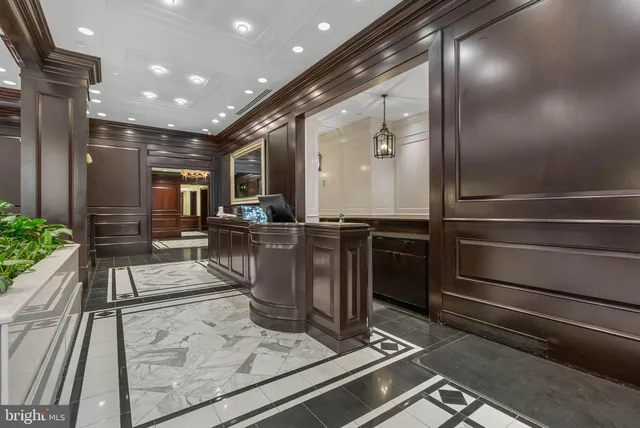 a living room with stainless steel appliances kitchen island granite countertop a stove and a refrigerator