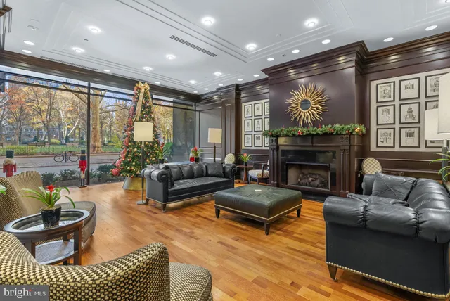 a living room with furniture a large window and a fireplace
