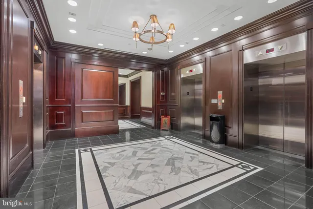 a view of lobby with a couch and a chandelier