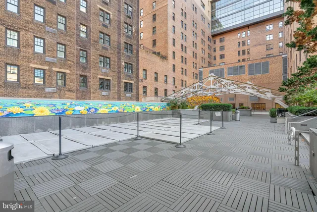 a street sign on a sidewalk next to a building