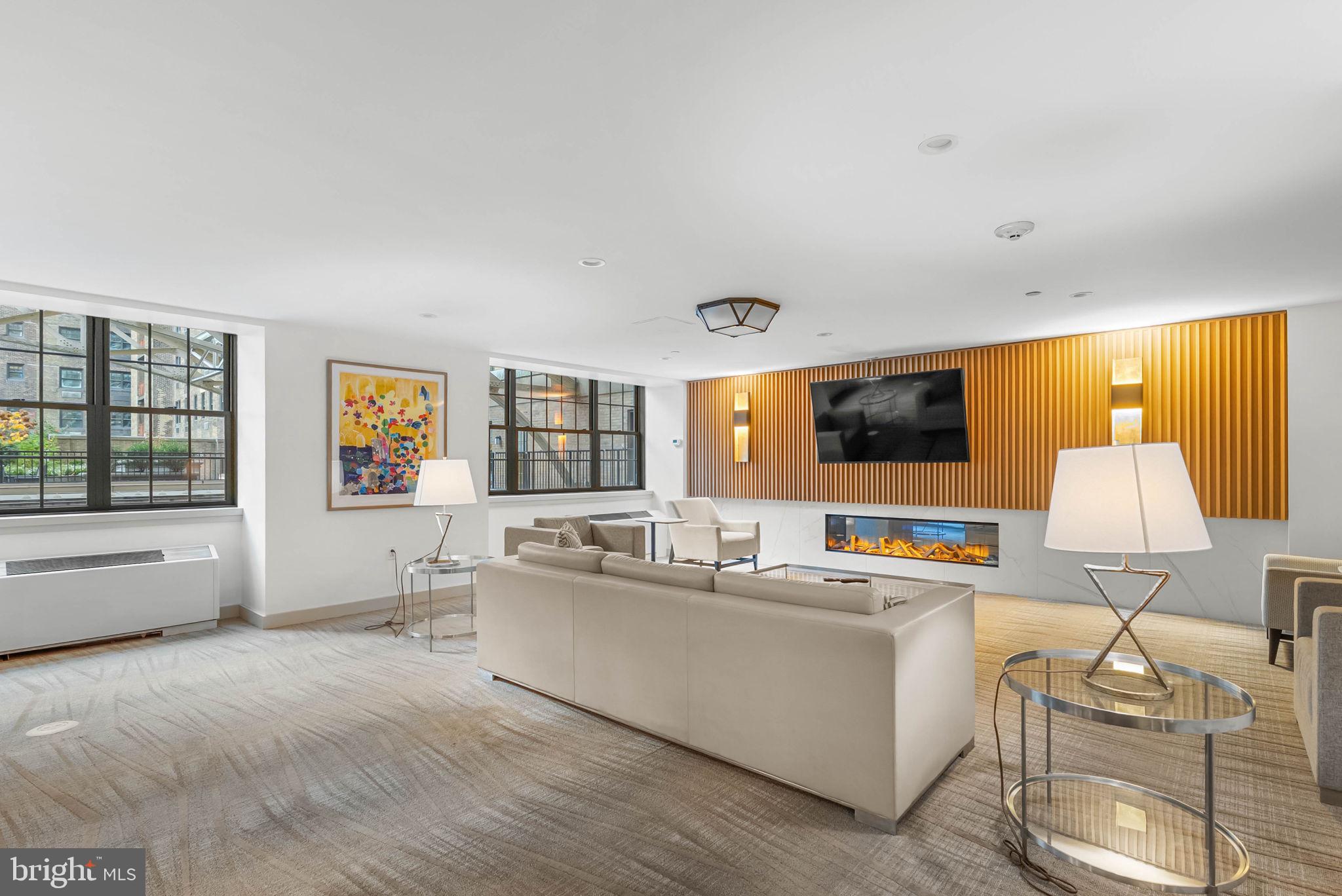 219 South 18th Street, Unit 404 Philadelphia, PA 19103 - Photo 21 of 24 a living room with furniture and a large window