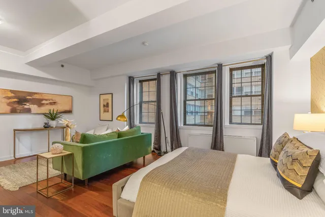 a bedroom with a bed and a large window