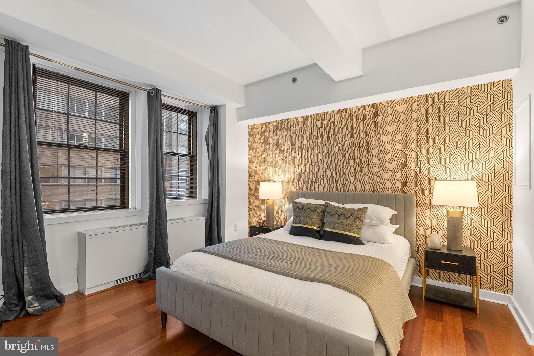 219 South 18th Street, Unit 404 Philadelphia, PA 19103 - Photo 5 of 24 a bedroom with a bed and wooden floor
