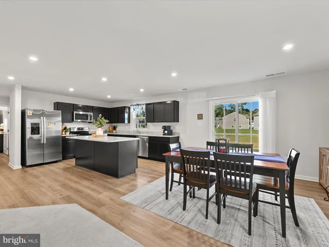 a kitchen with a table and chairs in it