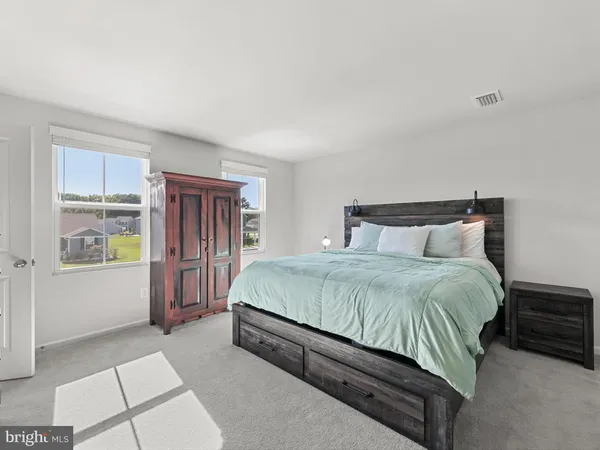 a bathroom with a granite countertop sink a toilet a shower and a mirror