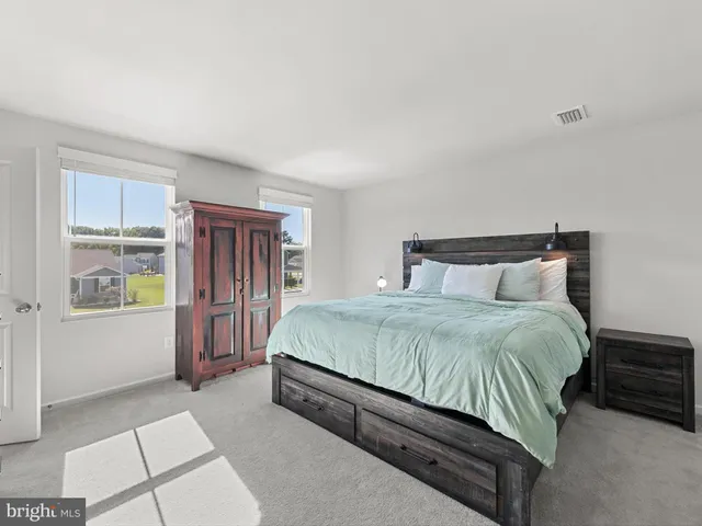a bathroom with a granite countertop sink a toilet a shower and a mirror