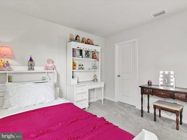 a bedroom with a bed and a table in it