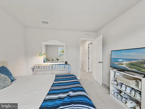 a bedroom with bed and a window