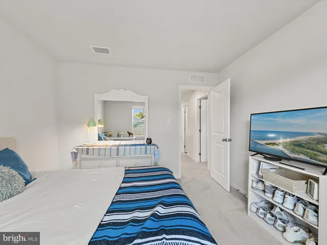 a bedroom with bed and a window