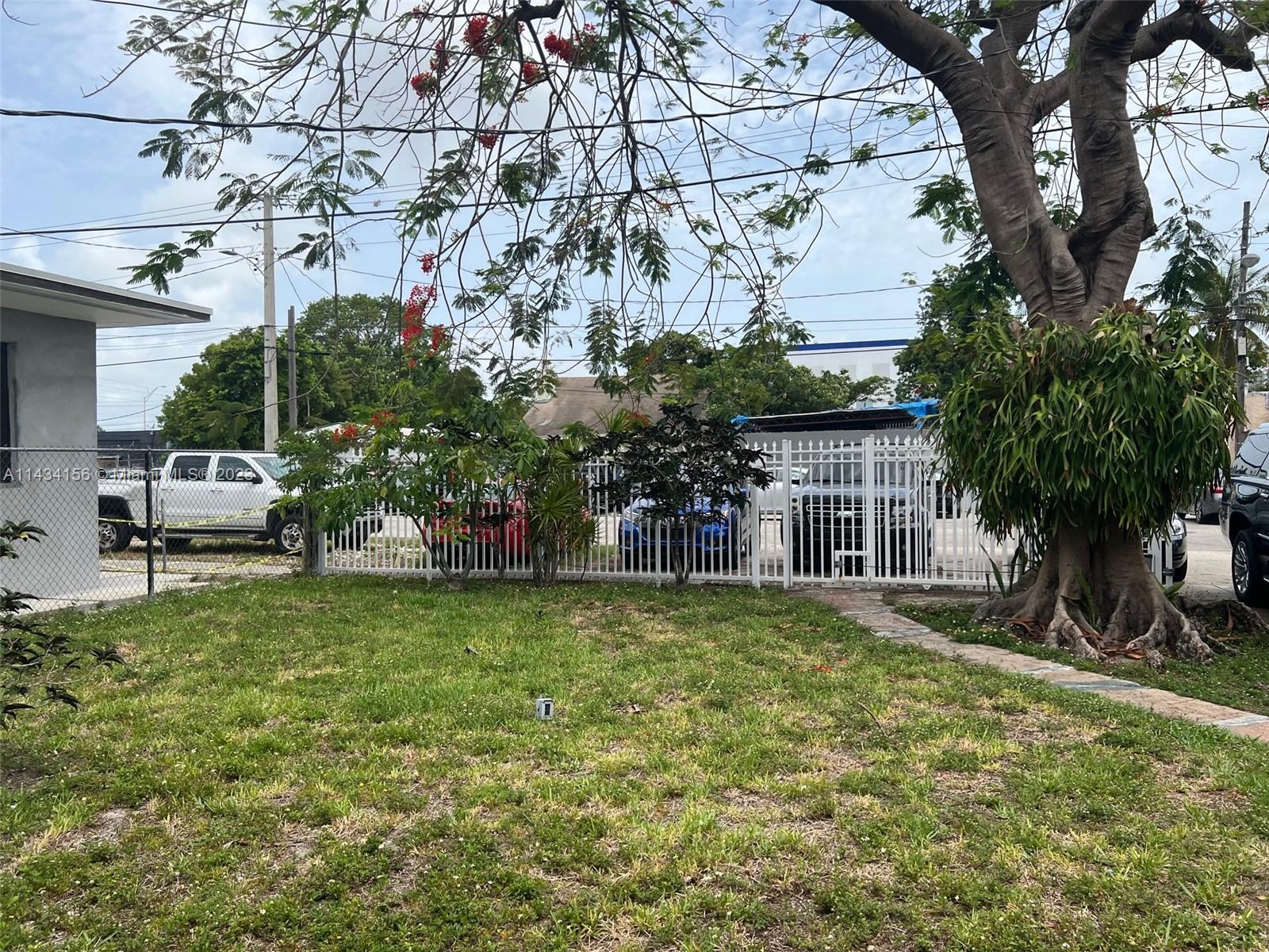 652 Northwest 28th Street Miami, FL 33127 - Photo 9 of 15 a backyard of a house with table and chairs